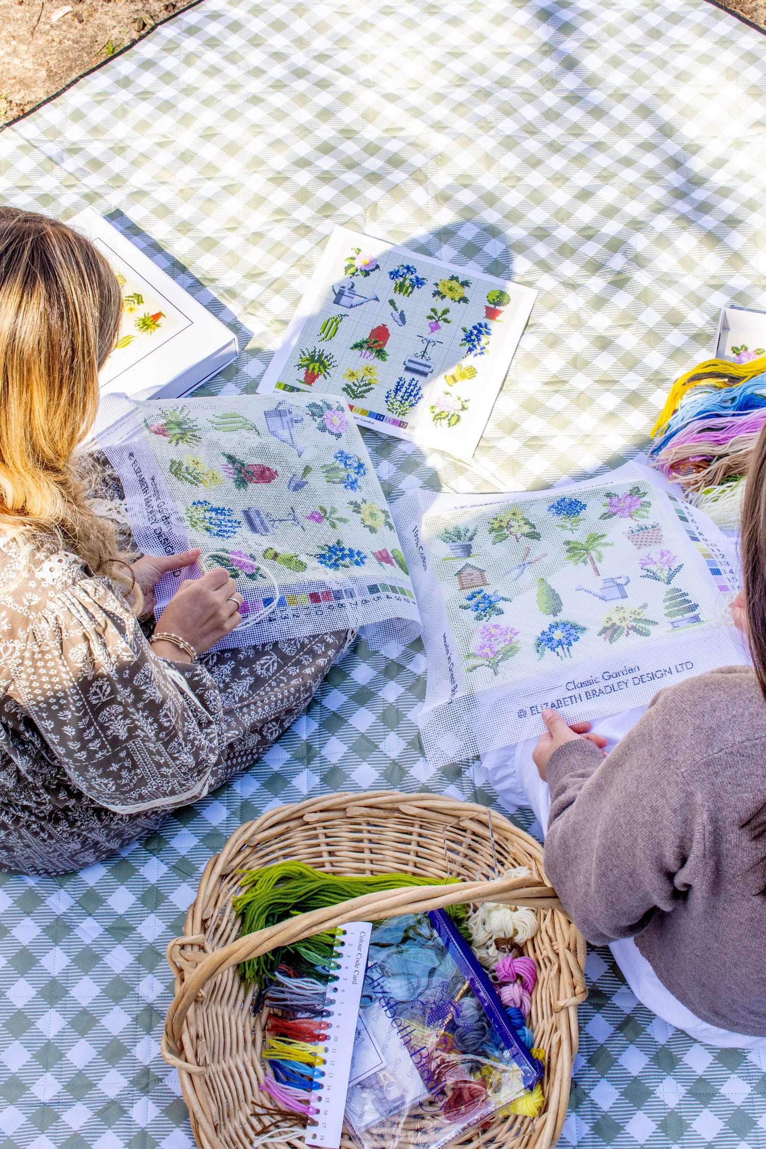 Finished Blue Perennial needlepoint cushions on couch