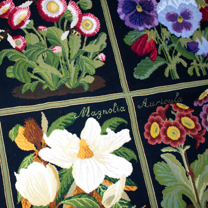 Needlepoint carpet featuring floral designs on a black background